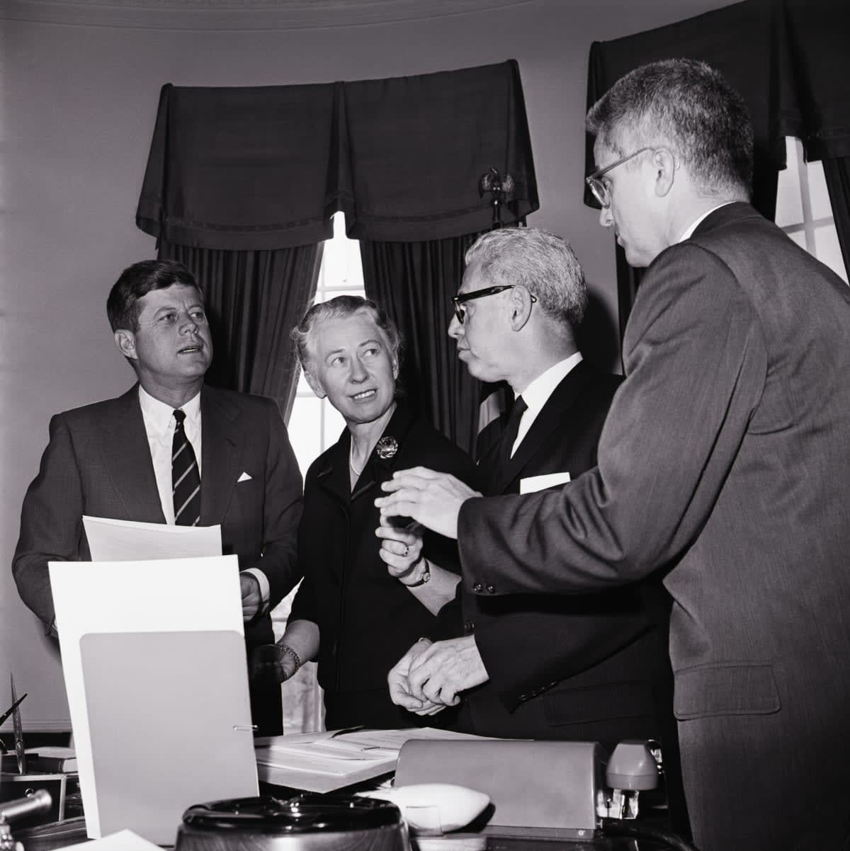 (Original Caption) 12/14/1961-Washington, D.C.: President Kennedy today set up a 26 member commision, headed by Mrs. Eleanor Roosevelt, to reccommend ways of insuring equal rights for women. Shown in the President's office after the commission was announced are, l-r: Pres. Kennedy; Assistant Secretary of Labor Esther Peterson, Executive Vice-Chairman of the Commission; Labor Secretary Arthur Goldberg, a member of the Commission, and John Macy, a member of the Civil Service Commission.

