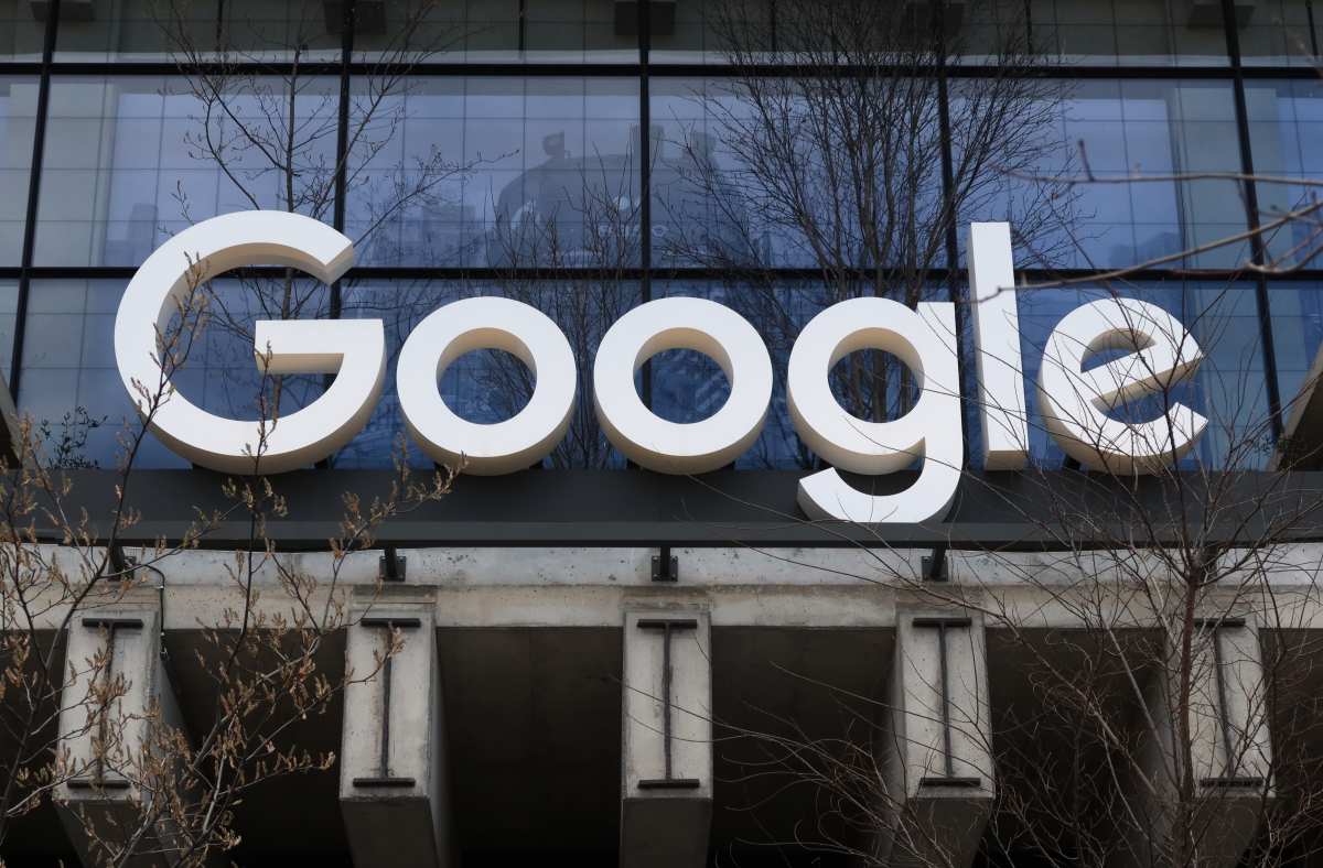 Image Source: A Google corporate logo hangs above the entrance to their office at St. John's Terminal on March 31, 2024, in New York City. (Photo by Gary Hershorn/Getty Images)