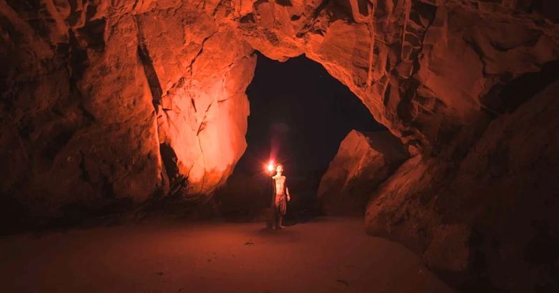 Man descends into a dangerous cave with just a rope and a flashlight to rescue childhood friend