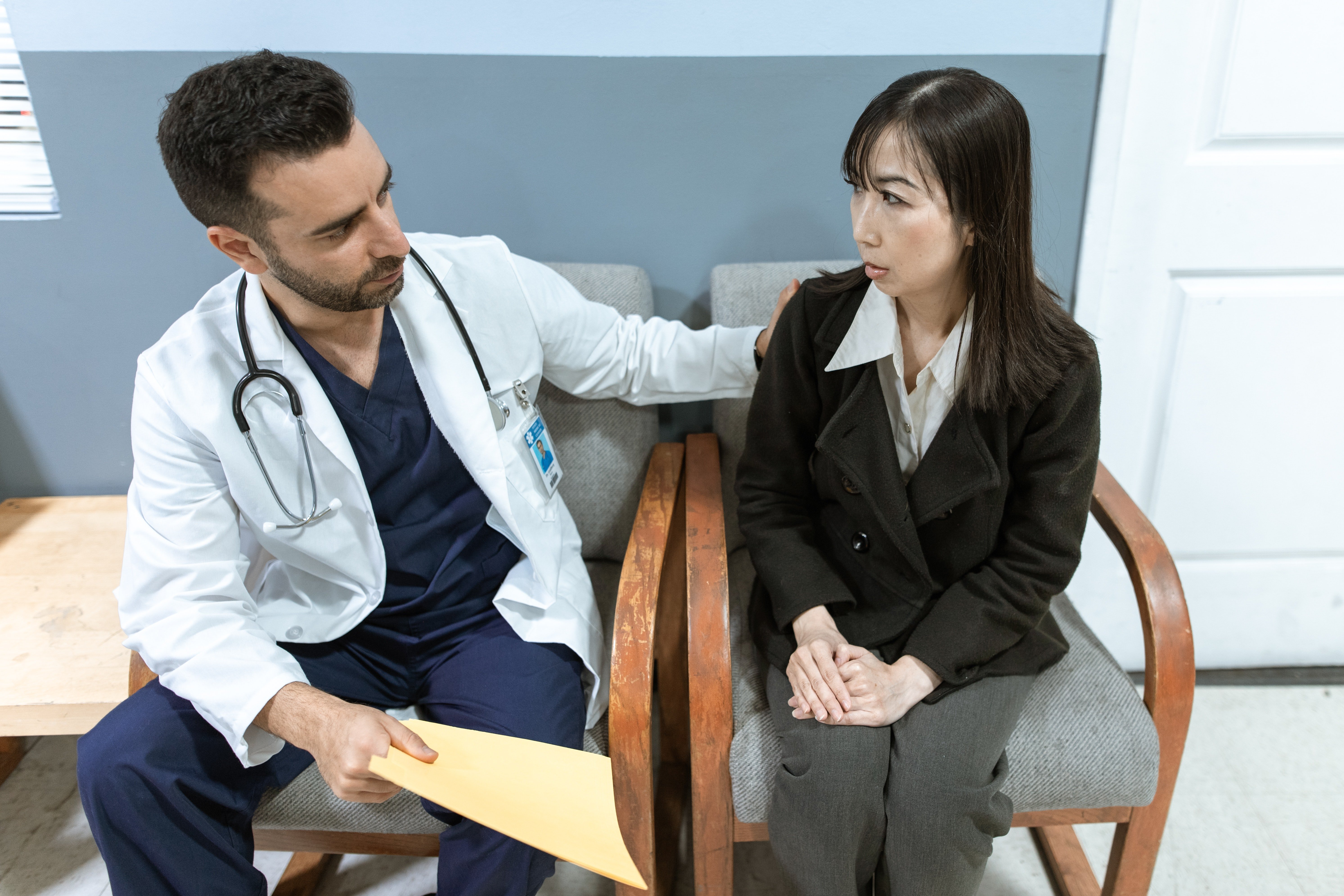 Doctor consoling a loved one.